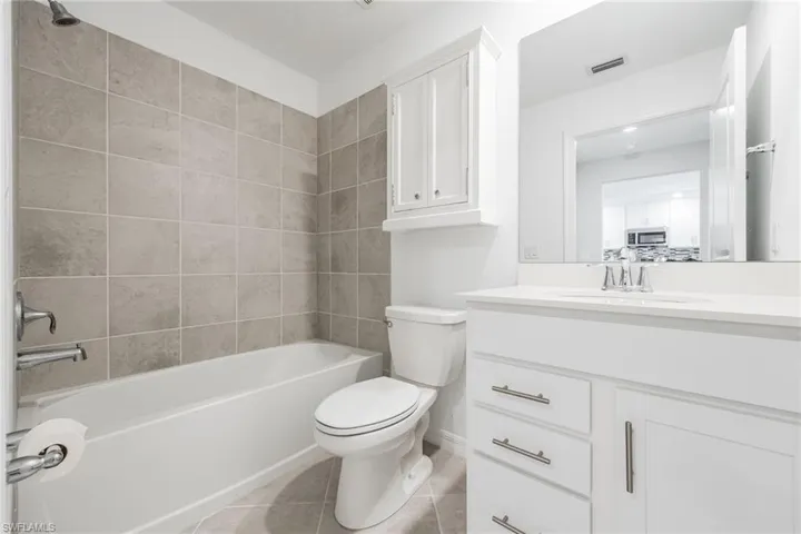 Guest bathroom with white vanity & tub/shower combination