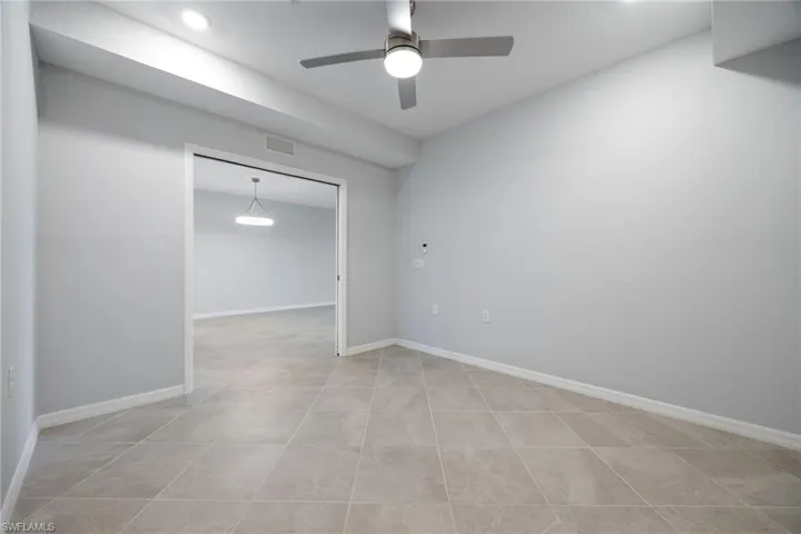 Den with a pocket door, ceiling fan and tile floors - ideal for a home office or additional guest accommodations