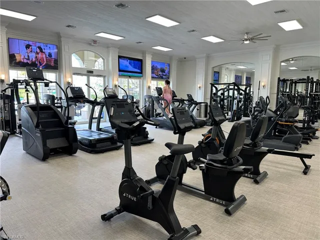 Gym featuring crown molding and ceiling fan