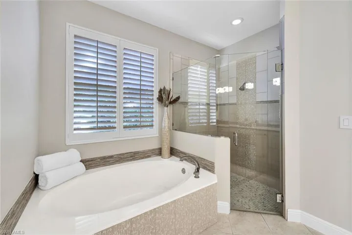 Bathroom featuring separate shower and tub and tile patterned floors