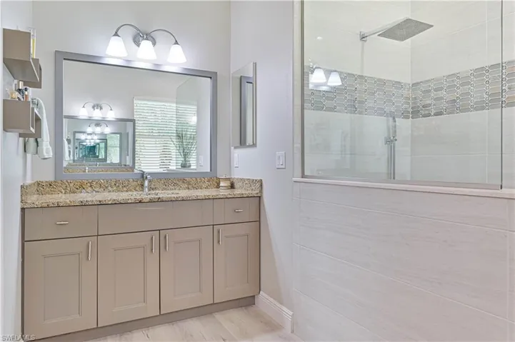 Bathroom featuring vanity and an enclosed shower