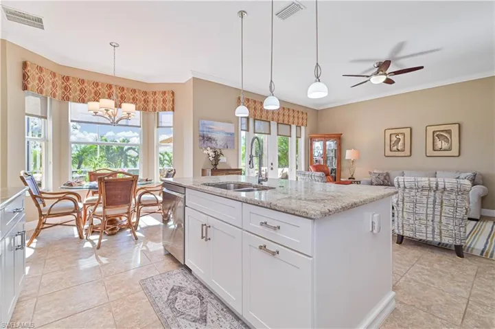 Kitchen with dishwasher, white cabinetry, sink, and a wealth of natural light