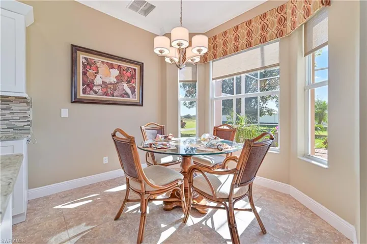 Dining area featuring a chandelier, a healthy amount of sunlight, and ornamental molding