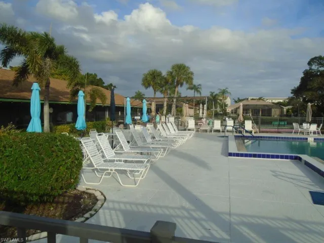 View of pool with a patio and fence