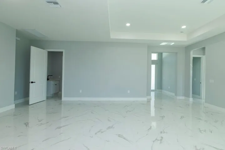 Unfurnished room with recessed lighting, baseboards, and visible vents