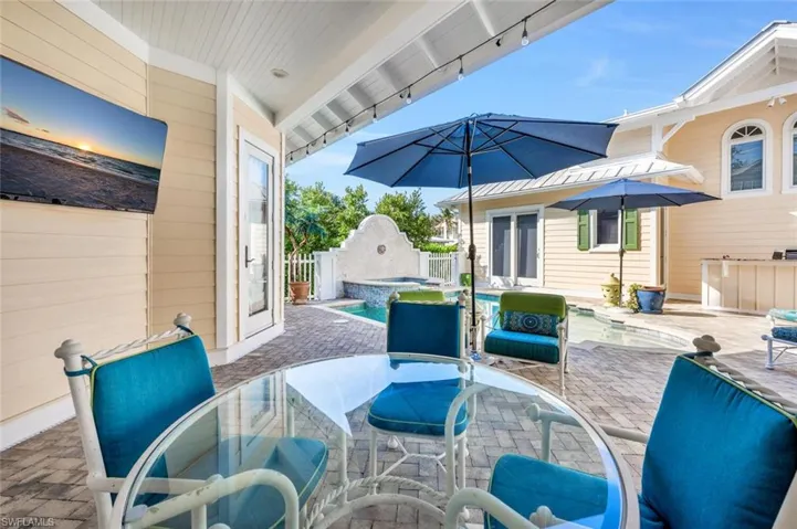View of patio / terrace with a pool with hot tub