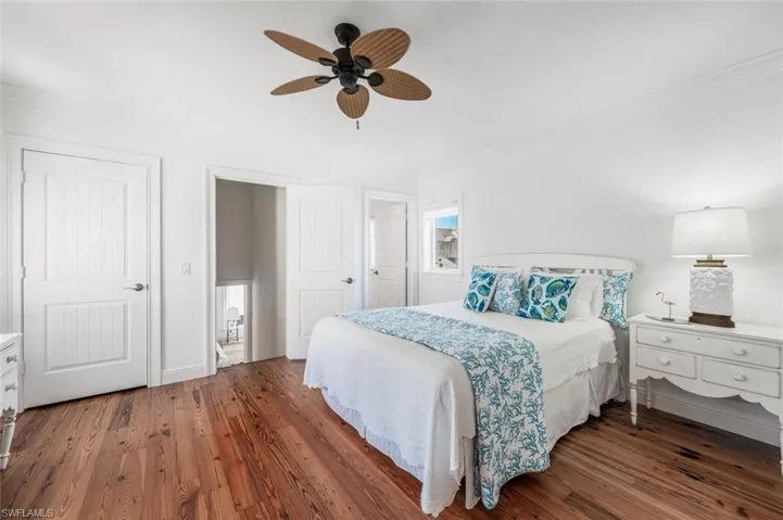 Bedroom featuring crown molding, ceiling fan, and dark hardwood / wood-style floors