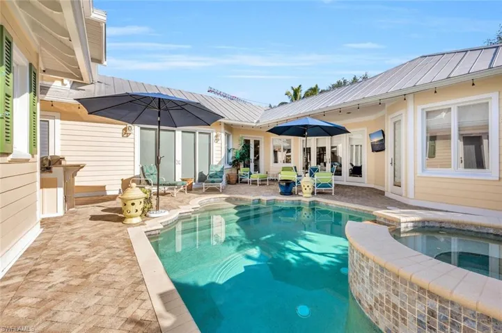 View of pool featuring an in ground hot tub and a patio