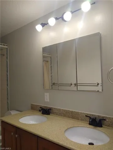 Full bathroom featuring double vanity and bathtub
