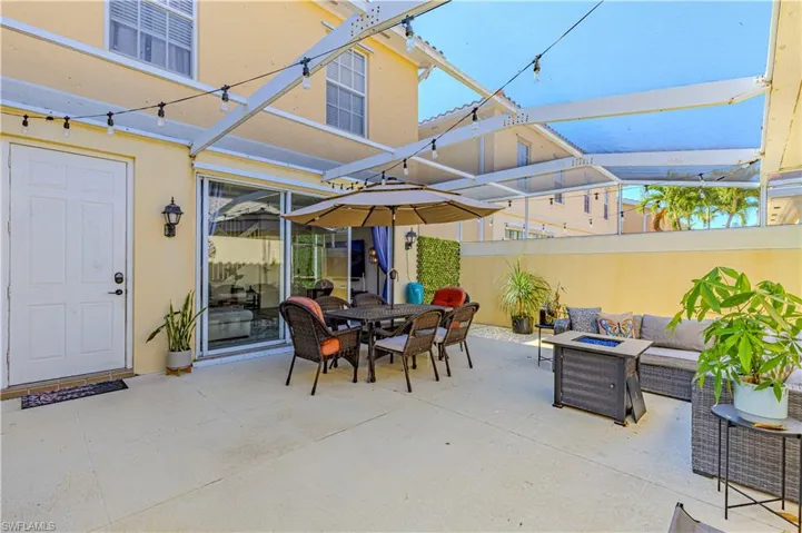 View of patio / terrace with a fire pit and outdoor dining space