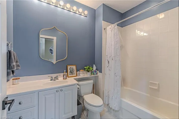 Bathroom with vanity and shower / bath combination with curtain