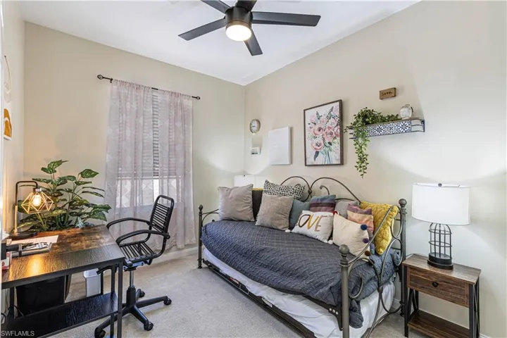 Bedroom with a desk, carpet flooring, and ceiling fan