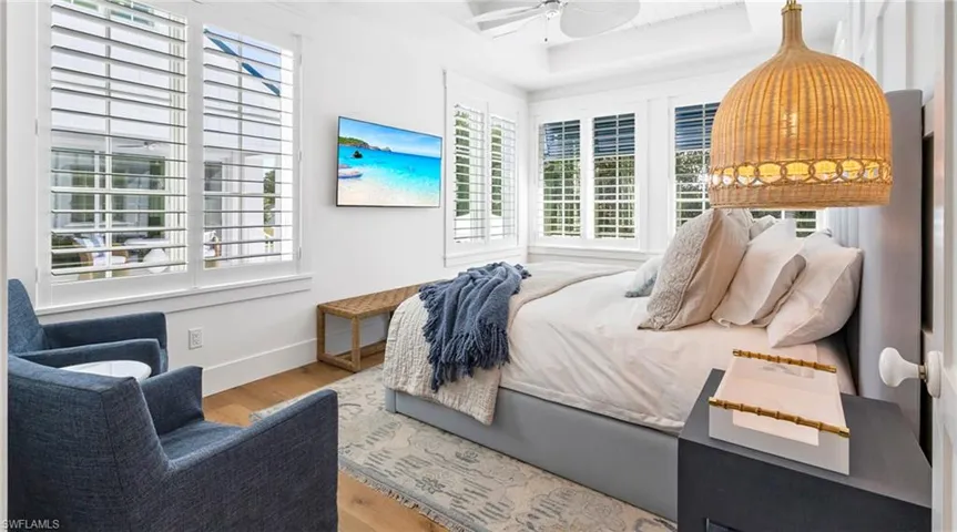 Bedroom with light wood-style floors and ceiling fan