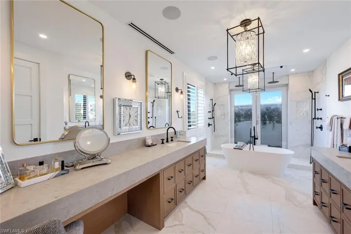 Large spa-like bath with dual showers behind french doors and sun walled patio for privacy