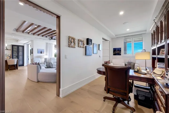 A quiet private office is a surprise behind 2 spectacular Pivot Doors that hide the office from the living room when closed