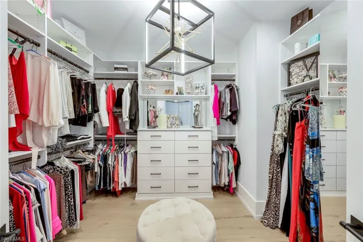 One of two custom closets offers the charm of a private room with all the specialty features