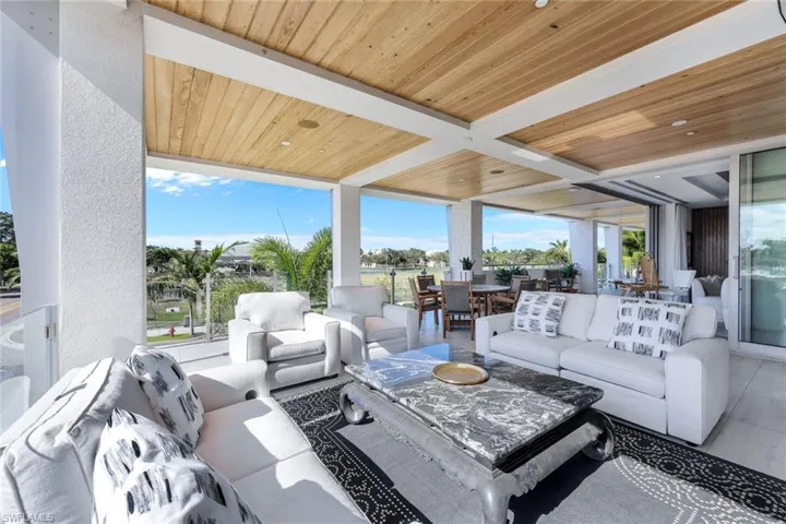 Large outdoor living with fireplace and TV for beautiful evenings on the lanai