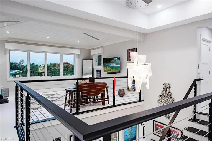 Hallway with beamed ceiling and a wall mounted air conditioner