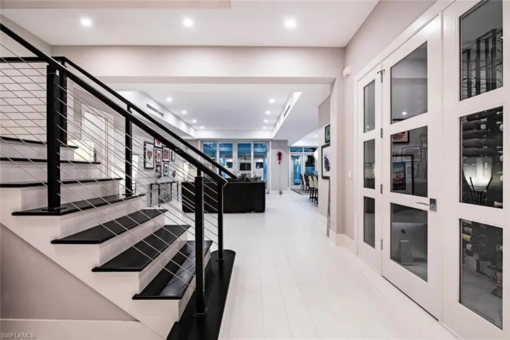 Hallway featuring french doors and light wood-type flooring