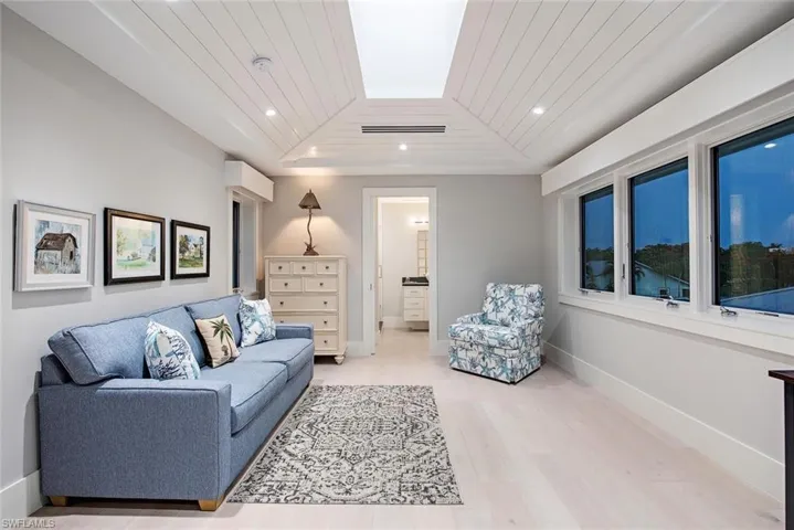 Living room with hardwood / wood-style flooring and wooden ceiling