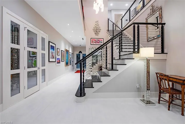 Stairs featuring french doors and hardwood / wood-style floors