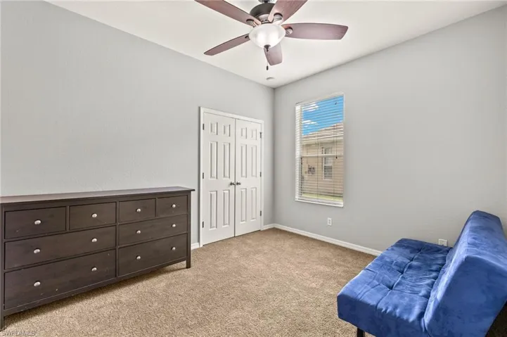 Sitting room with light carpet, ceiling fan, and baseboards