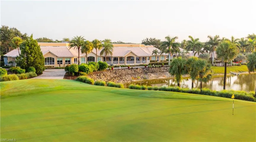 Surrounding community with view of golf course, a lawn, a water view, and a putting green