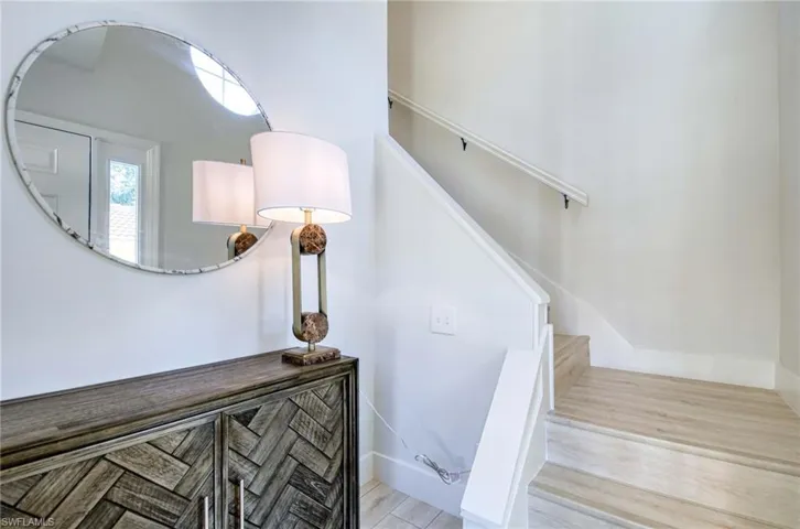 Staircase featuring wood finished floors and baseboards