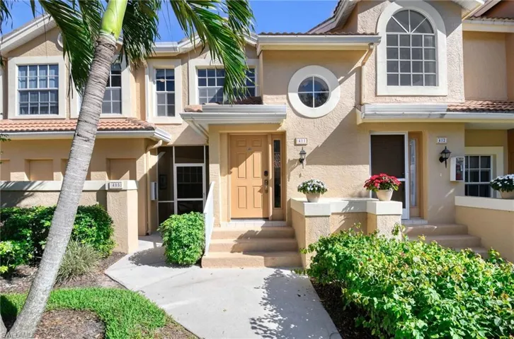 View of front of home with stucco siding and a tile roof