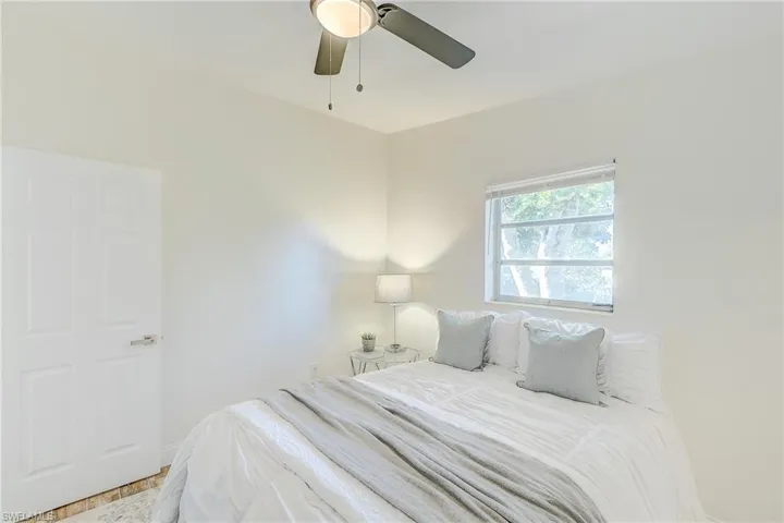 Bedroom with ceiling fan and baseboards