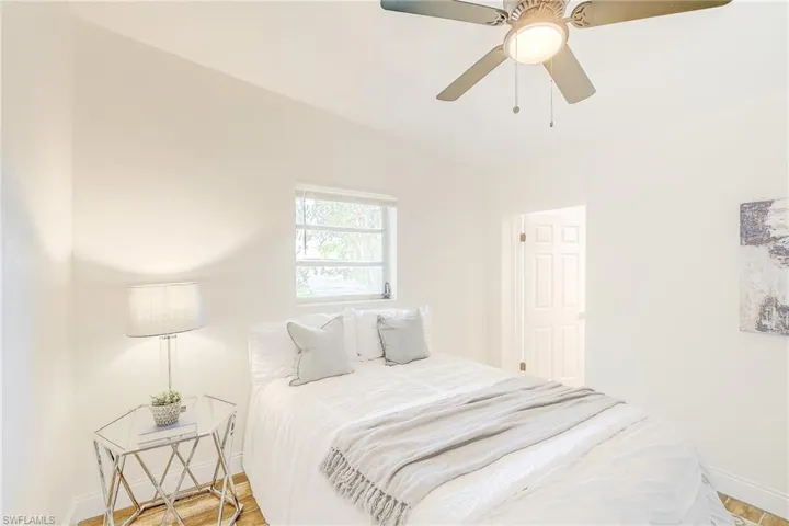 Bedroom with wood finished floors, baseboards, and a ceiling fan