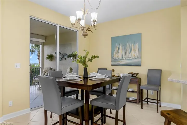 Tiled dining area featuring a chandelier