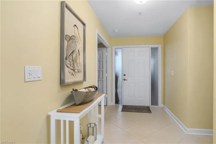 Doorway to outside featuring light tile patterned floors