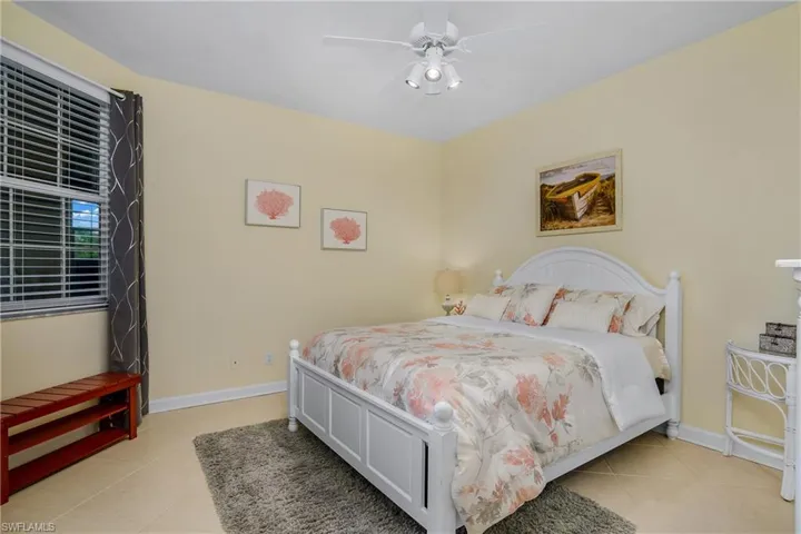 Bedroom featuring ceiling fan and light tile patterned flooring