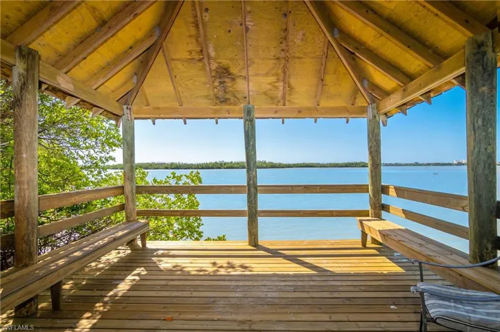 View of dock featuring a deck with water view and a gazebo