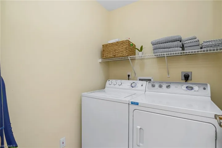 Clothes washing area featuring washer and clothes dryer