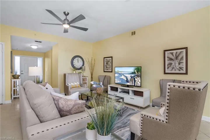 Living room featuring ceiling fan and light tile patterned floors
