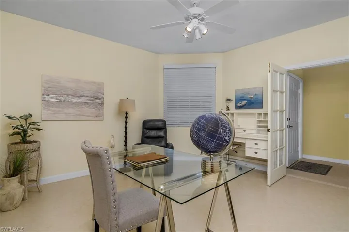 Tiled office space featuring ceiling fan