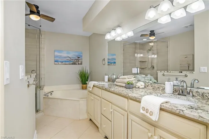 Bathroom with vanity, tile patterned floors, and shower with separate bathtub