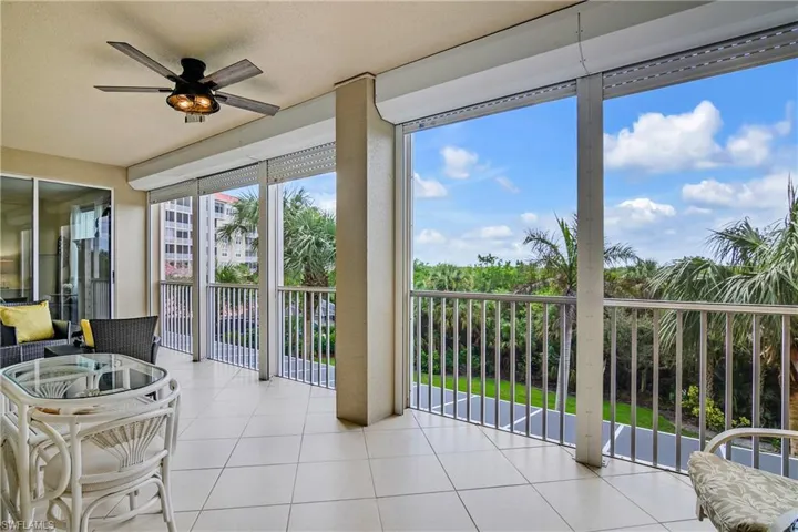 Sunroom / solarium featuring ceiling fan