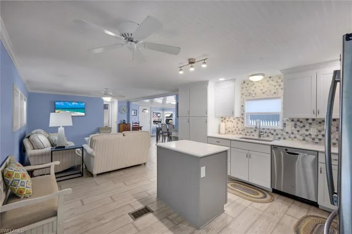 The property features an open-concept living area with a kitchen, a central island with a quartz countertop