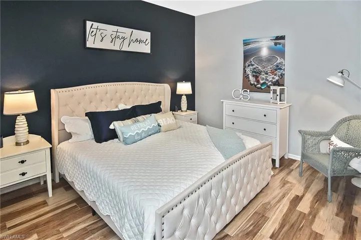 Bedroom featuring wood finished floors and baseboards