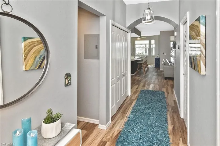 Bedroom with wood finished floors, ensuite bathroom, recessed lighting, and a ceiling fan