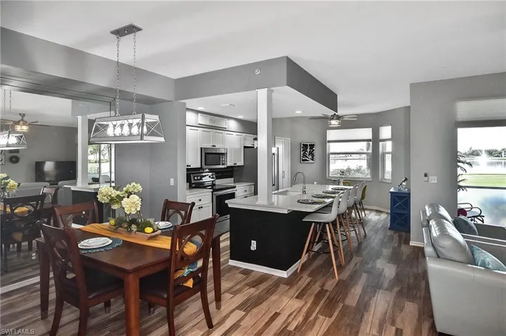 Dining room with a ceiling fan, dark wood-style flooring, and recessed lighting