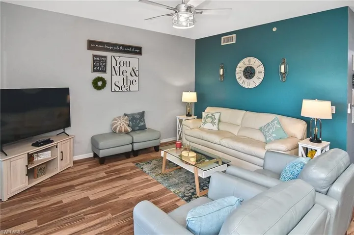 Living room with dark wood-type flooring