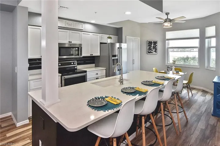 Dining space featuring ceiling fan, wood finished floors, and recessed lighting