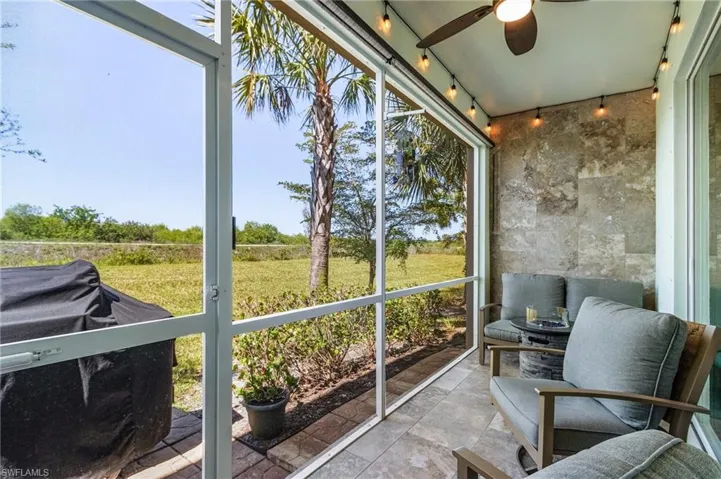 Sunroom / solarium featuring ceiling fan and rail lighting