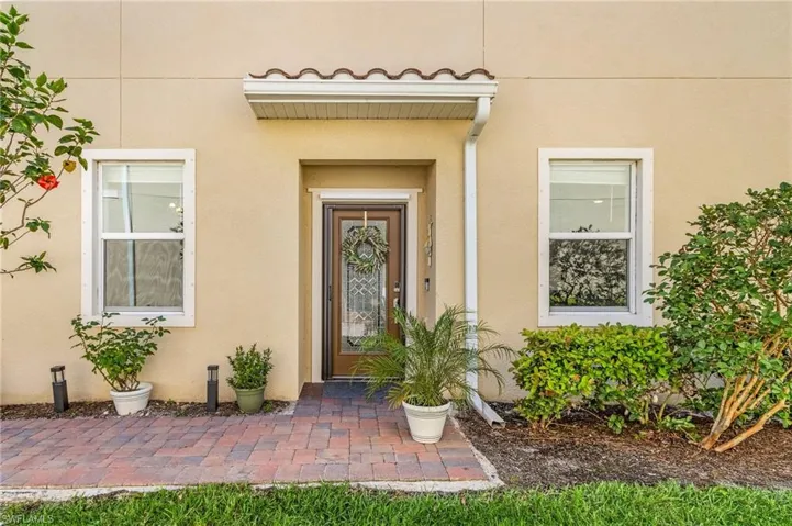View of exterior entry with stucco siding
