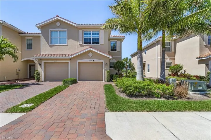 Mediterranean / spanish-style house with decorative driveway, stucco siding, an attached garage, central AC unit, and a tiled roof