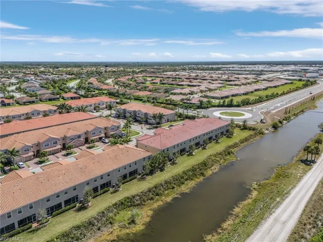 Birds eye view of property featuring a water view and a residential view